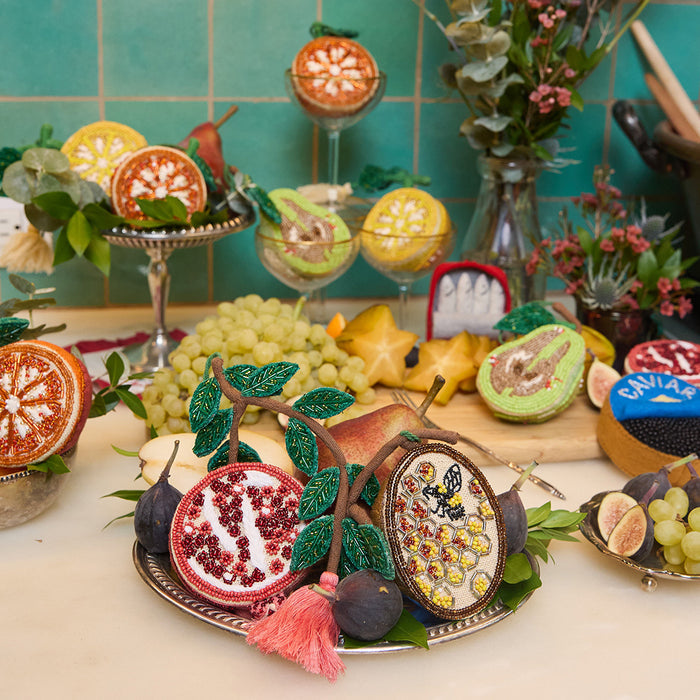 Heirloom-quality beaded ornament celebrating pollinators and harvest season