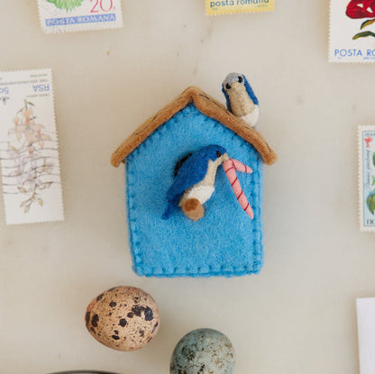 Fair trade birdhouse ornament crafted in Kyrgyzstan from natural wool, part of a garden-inspired ornament collection featuring birds, bees, and blossoms