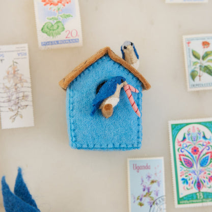 Eco-conscious felt birdhouse ornament with soft textures and natural tones, symbolizing peace, renewal, and the charm of garden life
