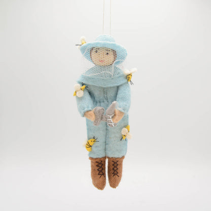 Blue felt beekeeper ornament honoring pollinators and sustainable farming practices