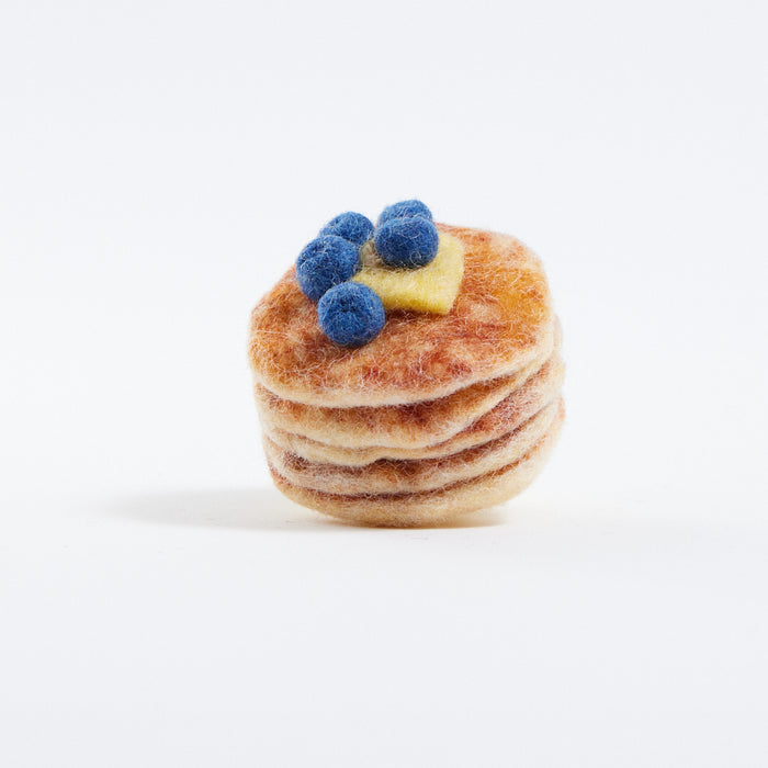 Felt pancakes, part of Blueberry-themed felt ornament gift set in a kraft box with crinkle paper. Includes a felt blueberry jam jar, blueberry pint basket, and blueberry pancake stack. Handmade from wool felt using traditional needle-felting. Fair trade and ready to hang.
