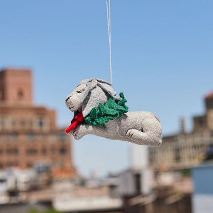 Handmade felt ornament of a regal lion statue adorned with a festive holiday wreath, inspired by the iconic lions outside the New York Public Library. Crafted from merino-blended wool, this ornament captures the spirit of NYC, literary tradition, and holiday cheer. A thoughtful gift for book lovers, librarians, and New York enthusiasts, perfect for trees, bookshelves, or desks. Ready to hang with a string attached.