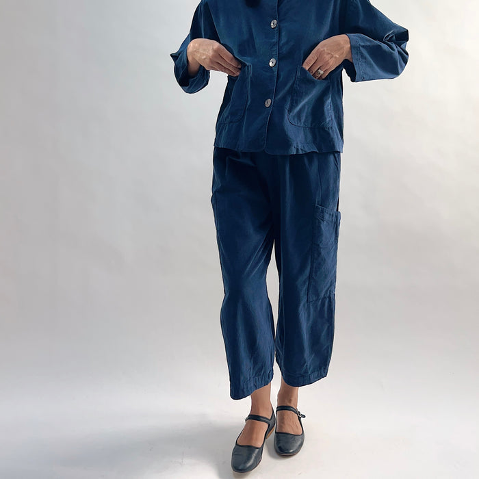 Model wearing the Bryn Walker Corduroy Pasha Pants in Nova paired with the matching Audrey Jacket, front view showing elastic waistband, hip pockets, and navy pinwheel corduroy, with black Mary Jane flats