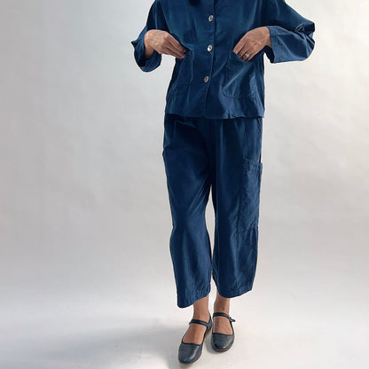 Model wearing the Bryn Walker Corduroy Pasha Pants in Nova paired with the matching Audrey Jacket, front view showing elastic waistband, hip pockets, and navy pinwheel corduroy, with black Mary Jane flats