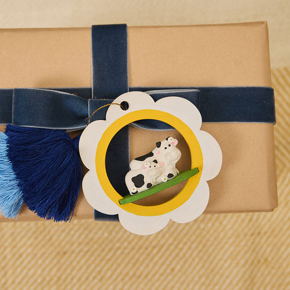 Wholesome mama and baby cow ornament featured in  gift wrap display