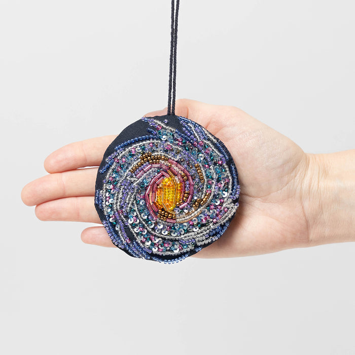 Explore the Milky Way with this stunning beaded galaxy ornament – a handmade cosmic keepsake for space lovers and science fans.