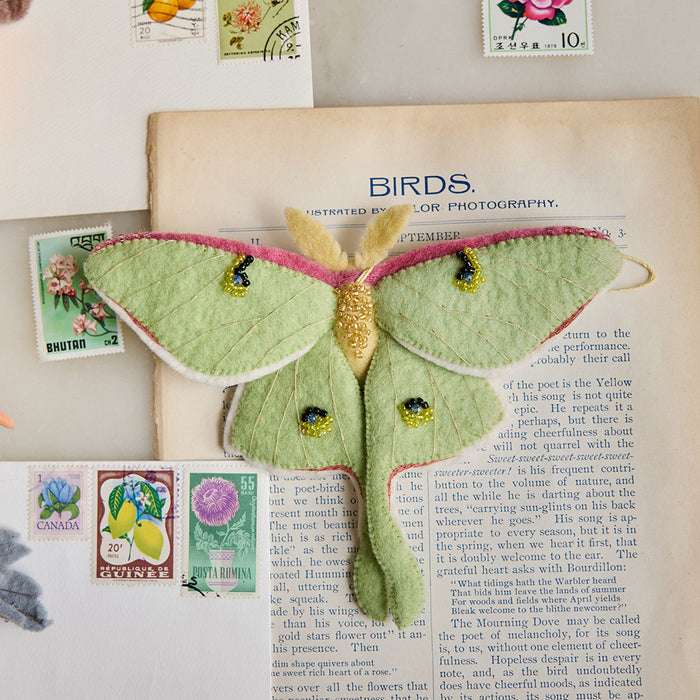 Ethereal green Luna Moth ornament with embroidered wings and beaded details, handcrafted from felted wool and inspired by the magic of twilight skies and woodland nature