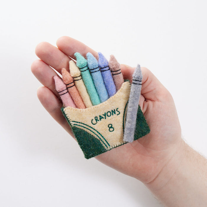Handmade pastel crayon box ornament crafted from felted merino-blend wool. Ethically made gift for teachers, creatives, and back-to-school celebrations.