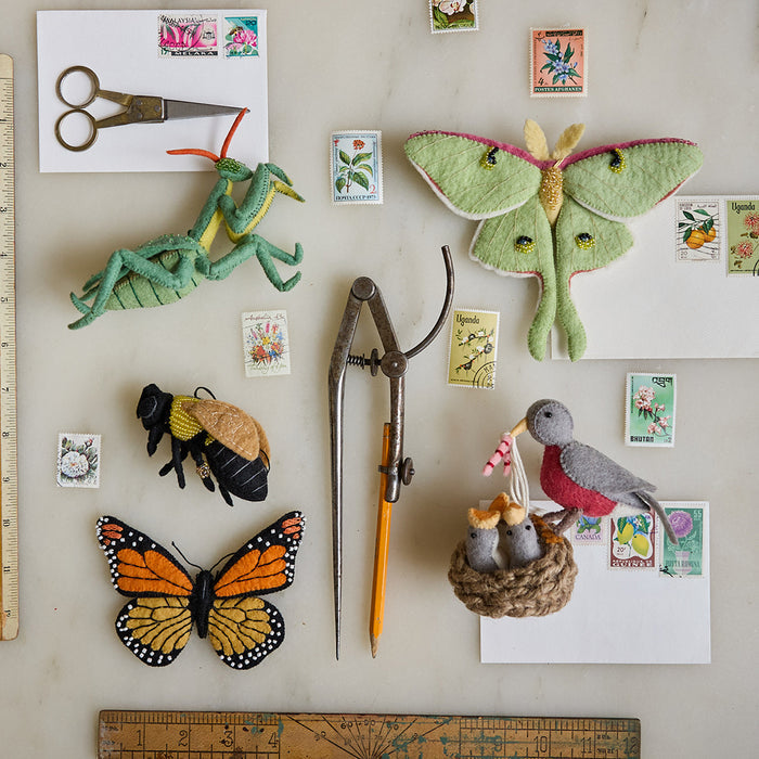 Felt wool Praying Mantis ornament with natural tones, bead accents, and delicate craftsmanship—an eco-conscious tribute to insect biodiversity