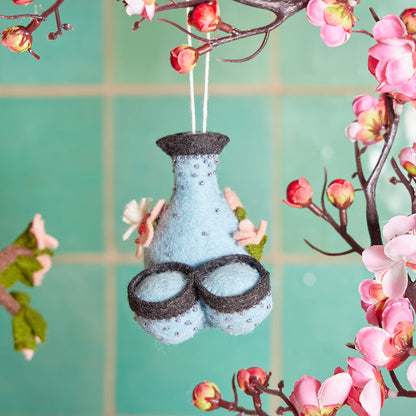 Felt sake pitcher and cup ornament with sakura blossom accents, handmade from wool and inspired by Japanese sake traditions.