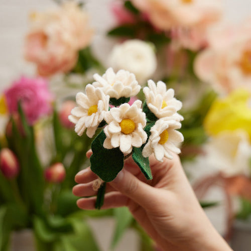 Handmade felt daisy flower bouquet with five white and yellow blooms in a recycled handblown glass vase. Eco-friendly spring décor or gift for Mother's Day, teachers, or Easter. Fair trade and sustainably crafted.