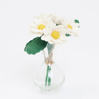 Handmade felt daisy flower bouquet with five white and yellow blooms in a recycled handblown glass vase. Eco-friendly spring décor or gift for Mother's Day, teachers, or Easter. Fair trade and sustainably crafted. n a clear glass bud vase.