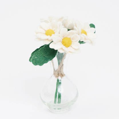 Handmade felt daisy flower bouquet with five white and yellow blooms in a recycled handblown glass vase. Eco-friendly spring décor or gift for Mother's Day, teachers, or Easter. Fair trade and sustainably crafted.  GIF 360 degree view