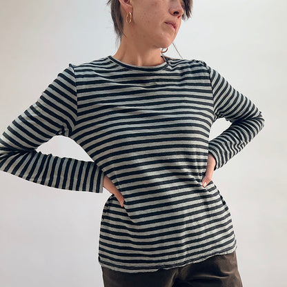 Cut Loose Striped Long Sleeve Easy Tee in Squirrel, black and grey stripe crewneck tee with hands on hips, worn with dark wide-leg trousers — front view showing fit and length