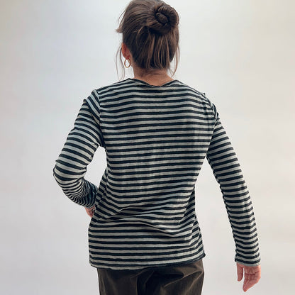 Cut Loose Striped Long Sleeve Easy Tee in Squirrel, black and grey stripe crewneck tee with hair in bun, worn with dark wide-leg trousers — back view showing seam detail and hem